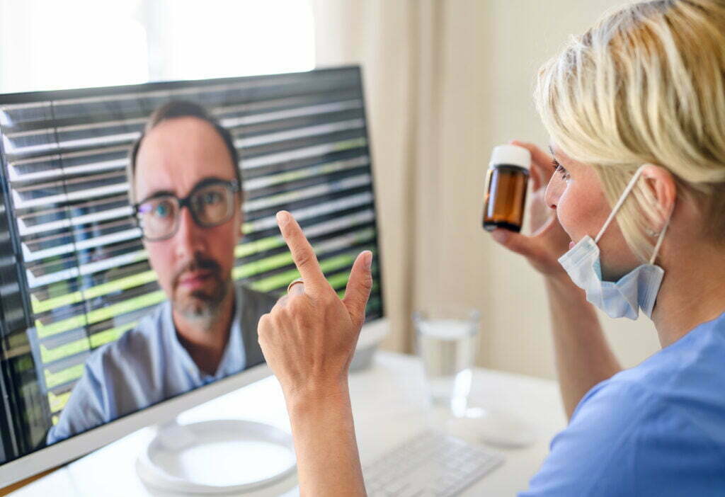 doctor using remote patient monitoring with patient