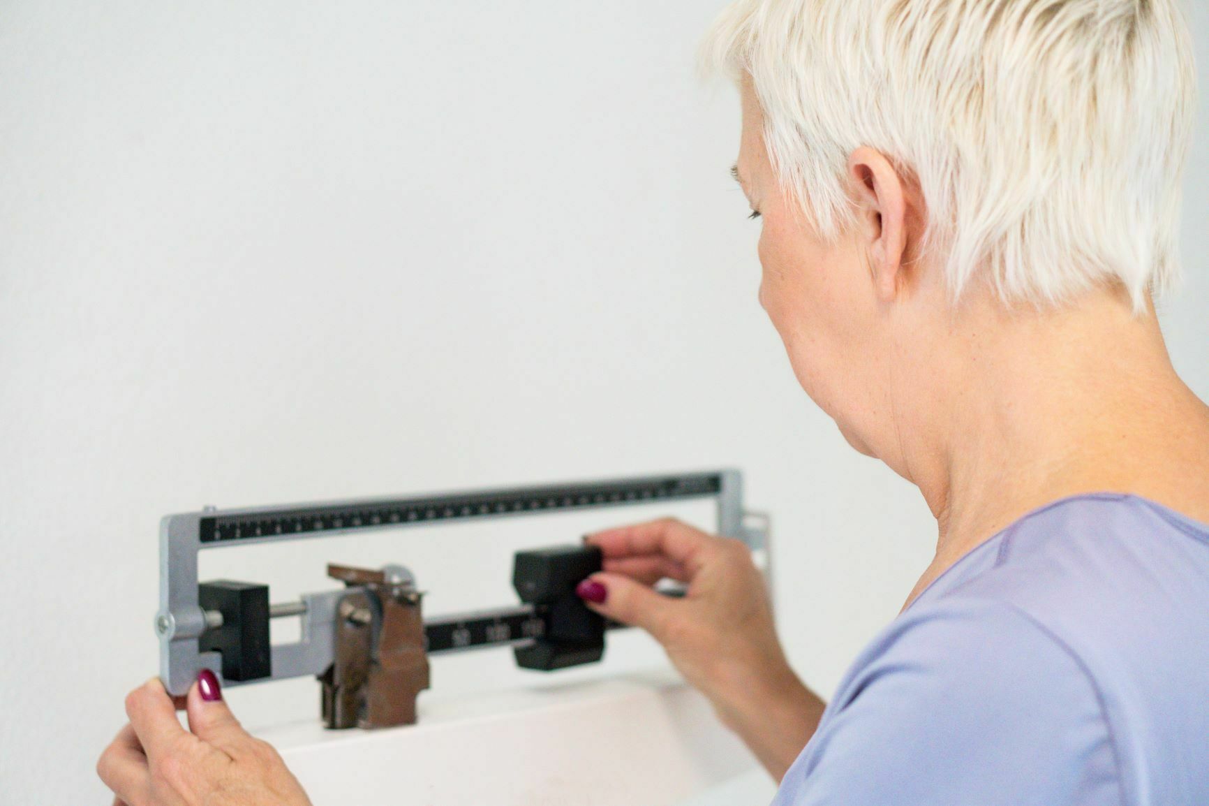 woman on scale measuring weight woman on scale measuring weight