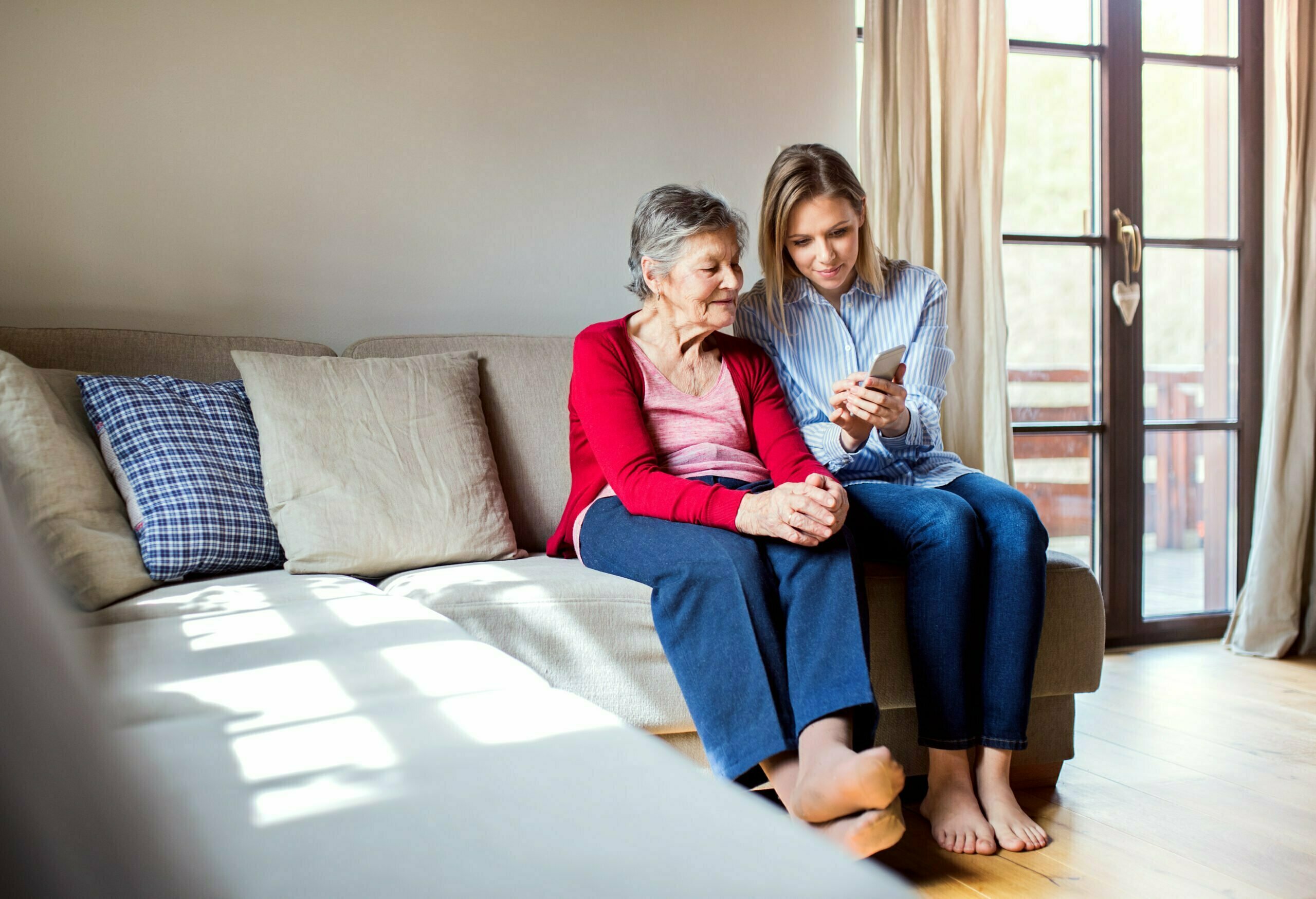 granddaughter guiding grandmother on smartphone use granddaughter guiding grandmother on smartphone use