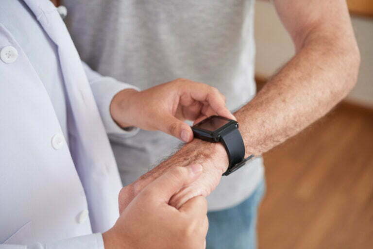 doctor measuring respiratory rate of patient with smart watch