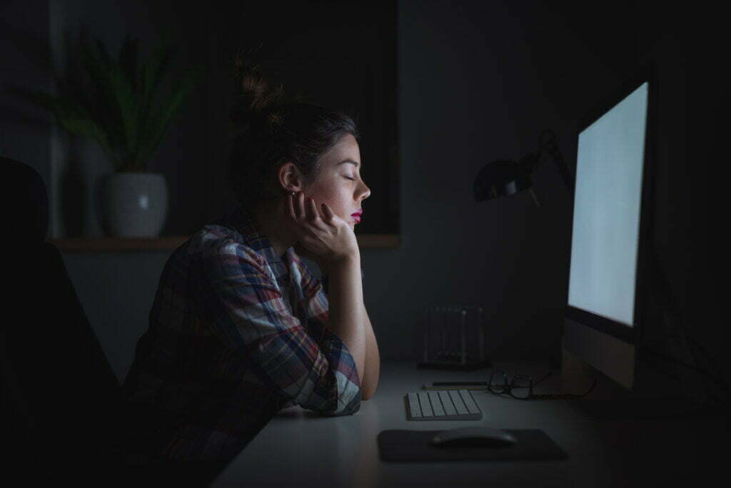 woman experiencing zoom fatigue during a meeting
