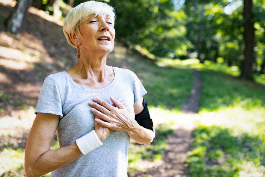 Senior woman exercising outdoors to prevent cardiovascular diseases and heart attack