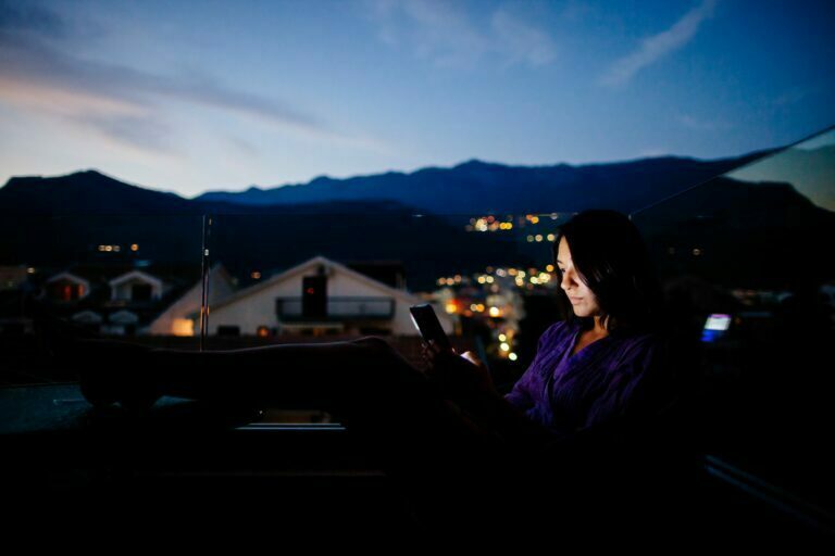 woman using smartphone at night woman using smartphone at night
