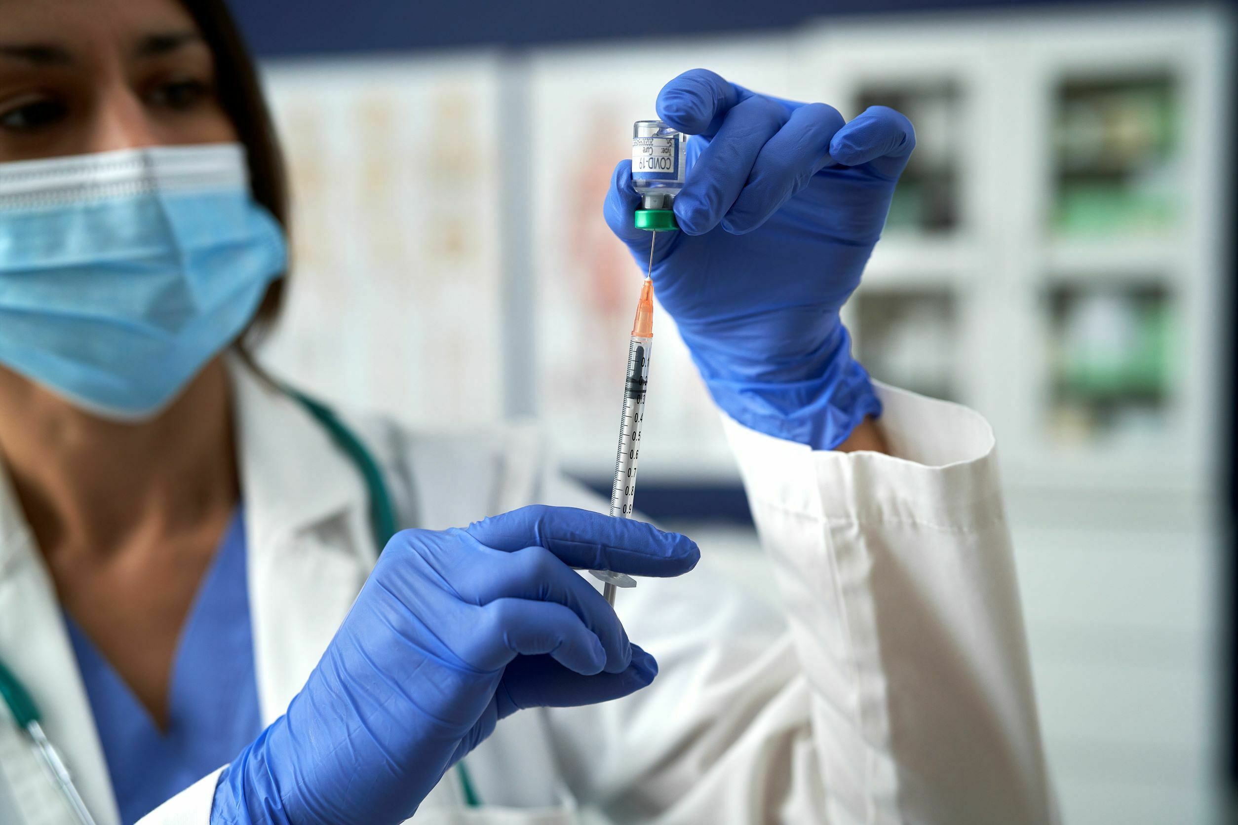 doctor with syringe for covid booster shots