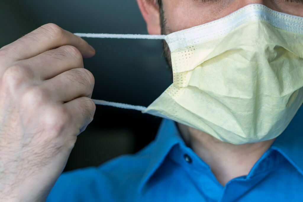 man putting on face mask
