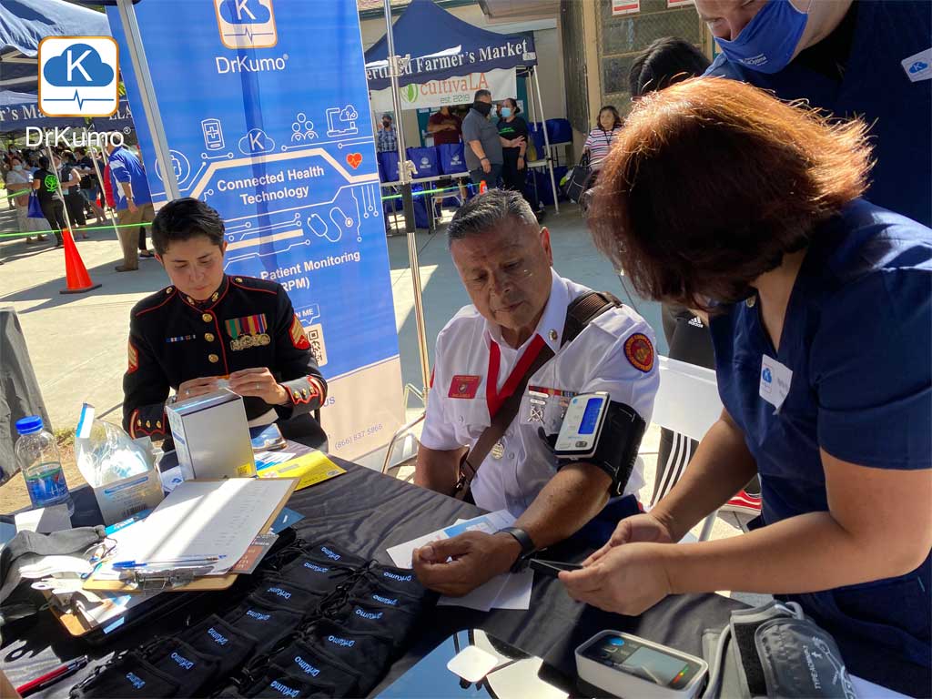 DrKumo Medical Team assists a Military Veteran in taking blood pressure measurement using DrKumo BP monitor for RPM at the Veterans Day Event, November 11, 2021.