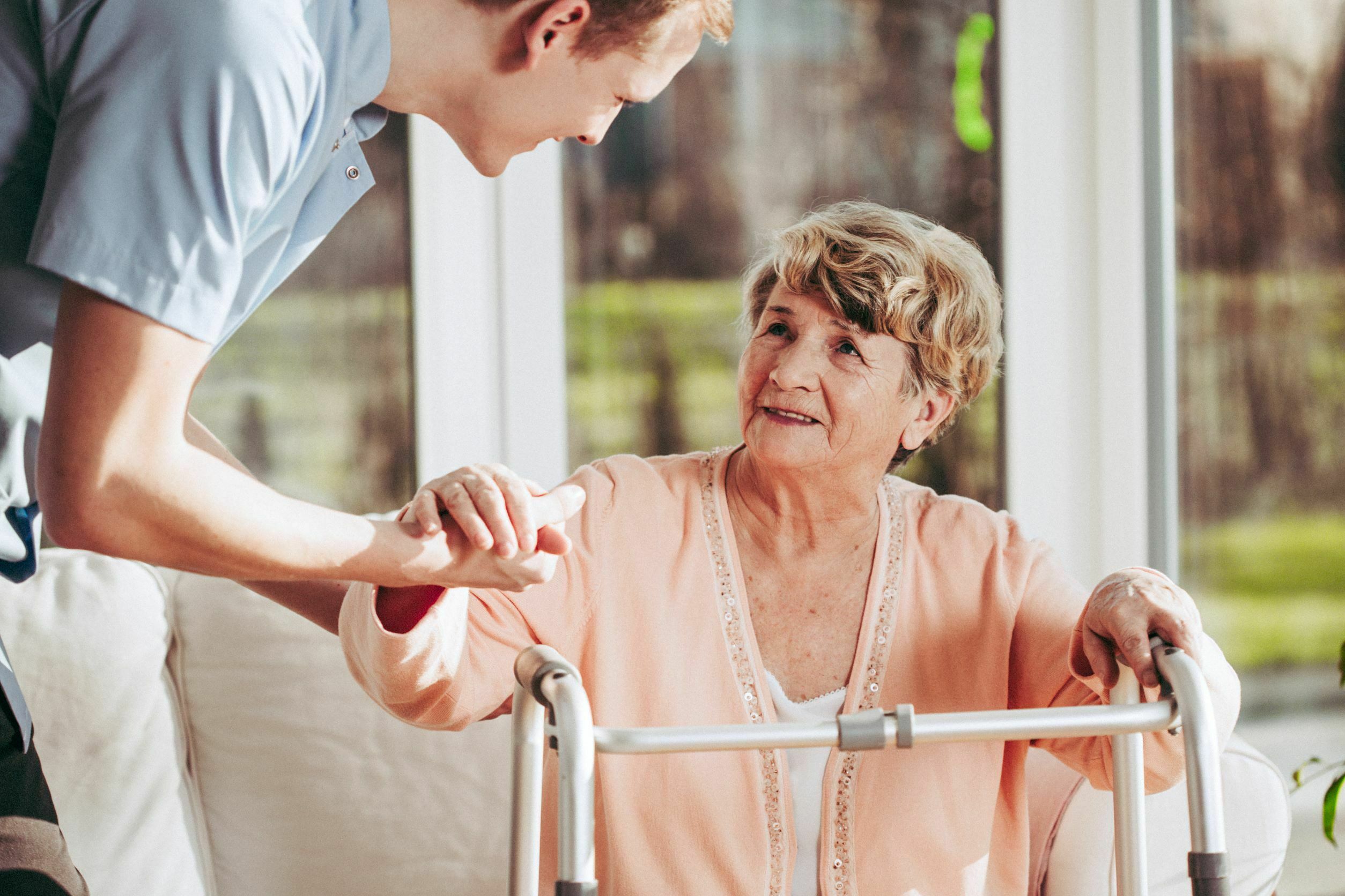 helping senior with Alzheimer's disease to stand up helping senior with Alzheimer's disease to stand up