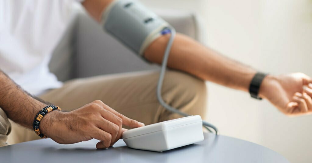 man taking bp measurements using own medical device