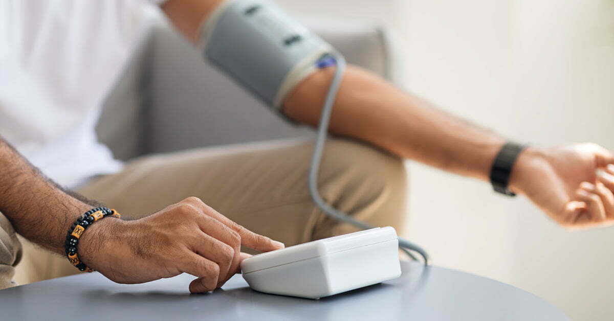 man taking bp measurements using own medical device
