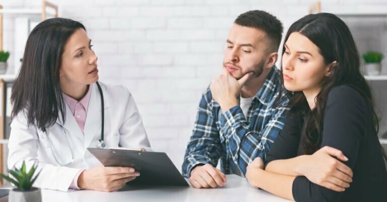 couple reading doctor prescription for infertility cure couple reading doctor prescription for infertility cure