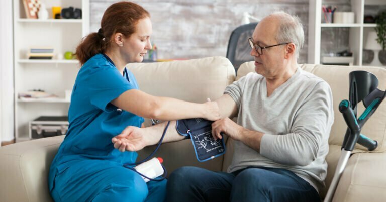 doctor taking bp measurements using digital blood pressure monitor