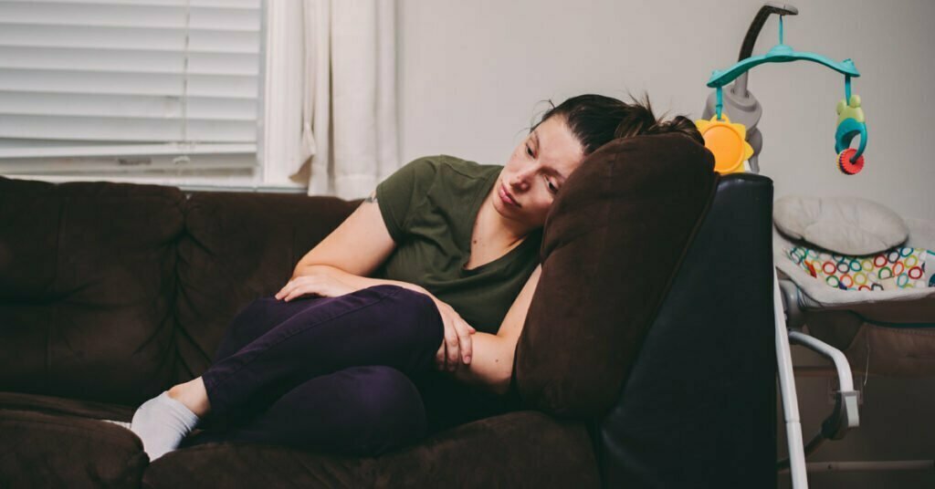 mother who is feeling lonely and sad due to postpartum