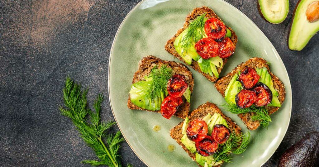 avocado toast with roasted tomatoes in a plate