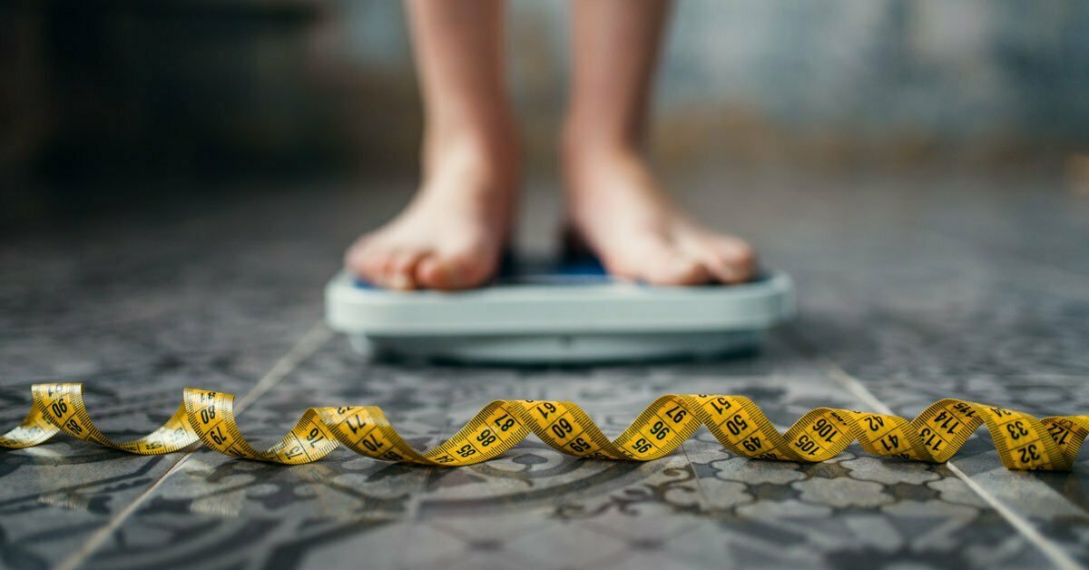 female feet on scale measuring tape, anorexia nervosa female feet on scale measuring tape, anorexia nervosa