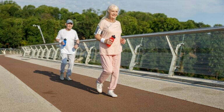 man and woman in their 50s using health wearable technology