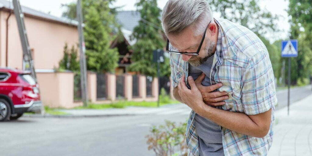 middle age man having heart attack on the street