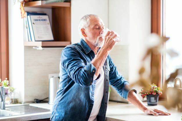 old man drinking water as one of the ways to prevent kidney stones