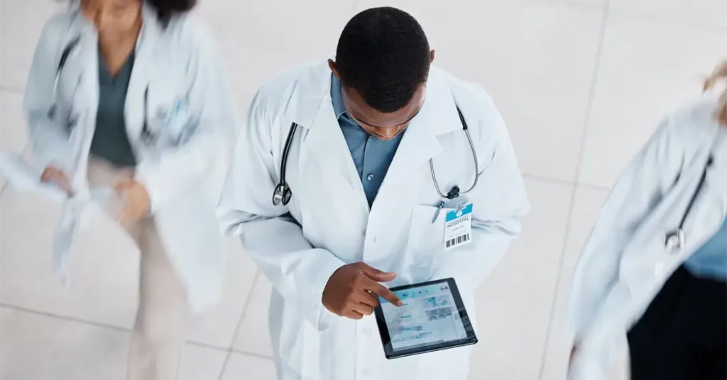 remote patient monitoring doctor scanning tablet for patient health data