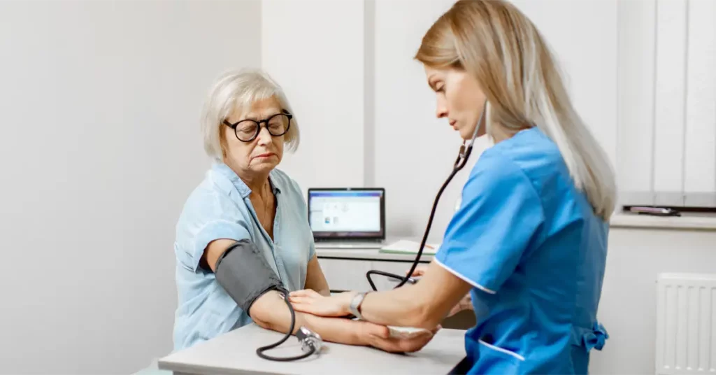 caregiver checks patient blood pressure reduce stroke risk