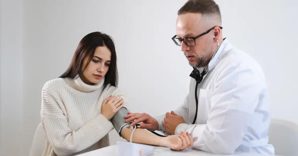 doctor measure patient blood pressure to check for hypostatic hypertension