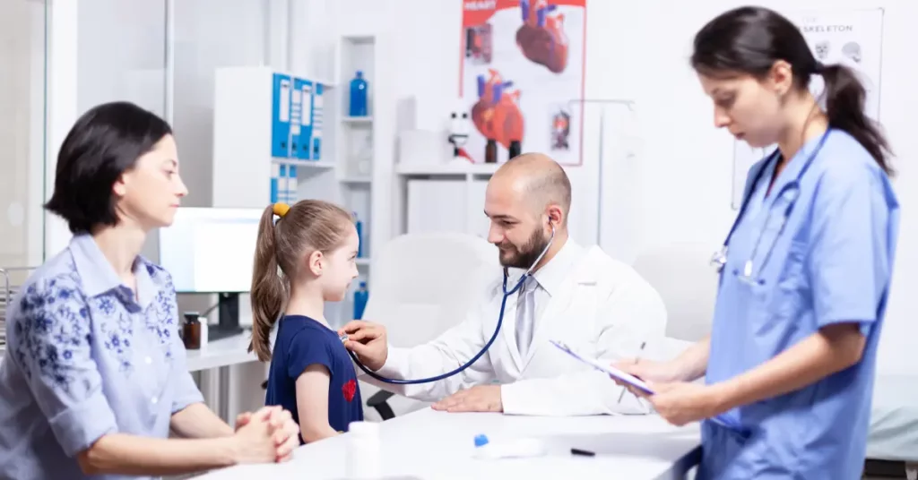 pediatrician examines child for congenital heart defect