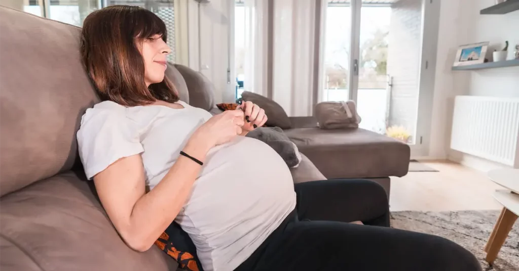 woman tests glucose based on normal blood sugar levels chart during pregnancy