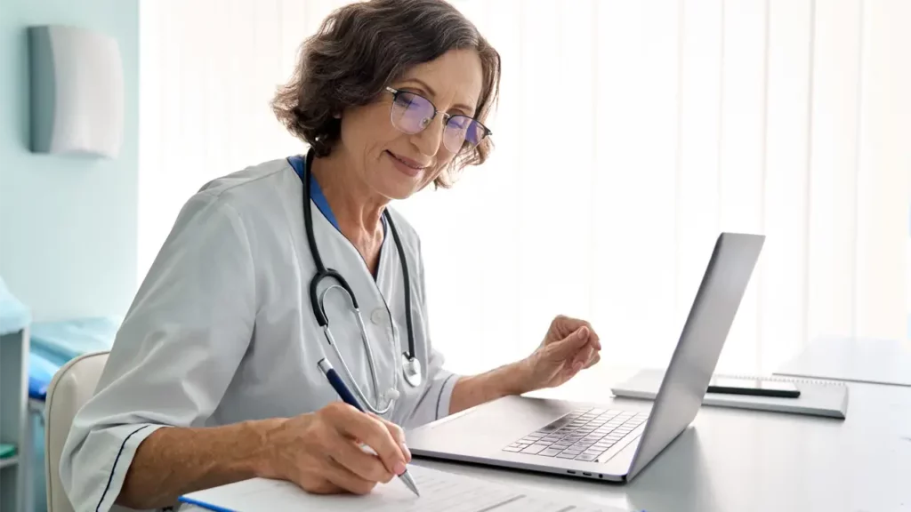 doctor doing patient monitoring using data from remote devices