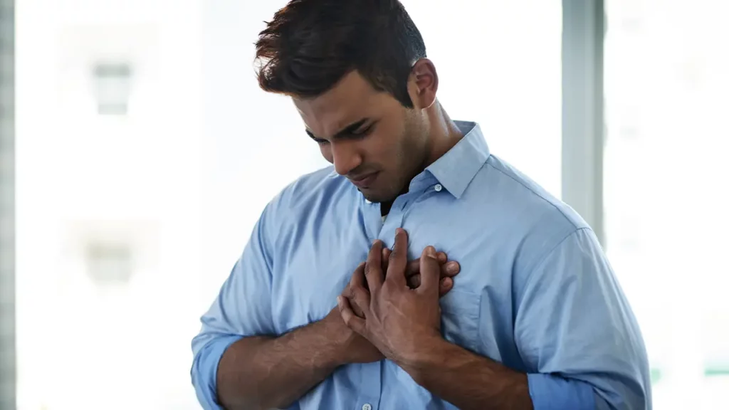 sneaky signs of heart disease man suffering with chest pain