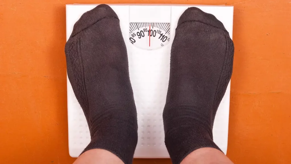 weight management, man in weighing scale