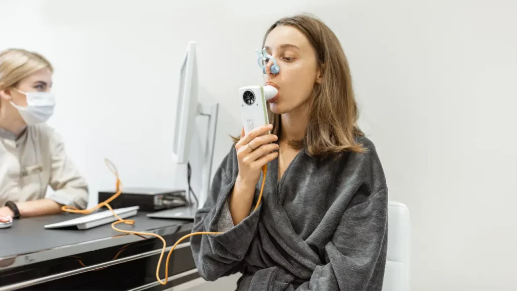 woman during a copd test using spirometry