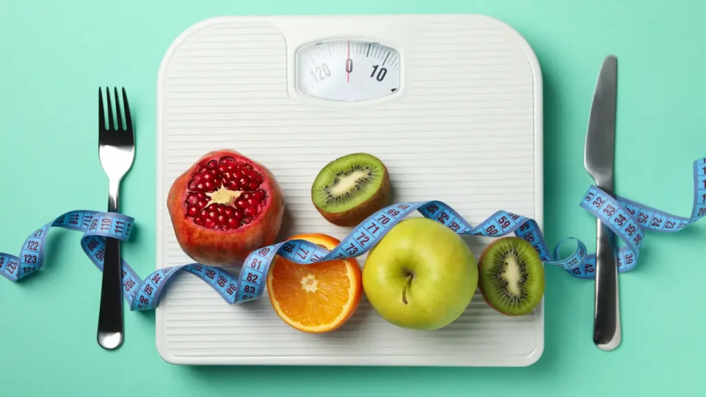 weight management and nutrition fruits in a weighing scale