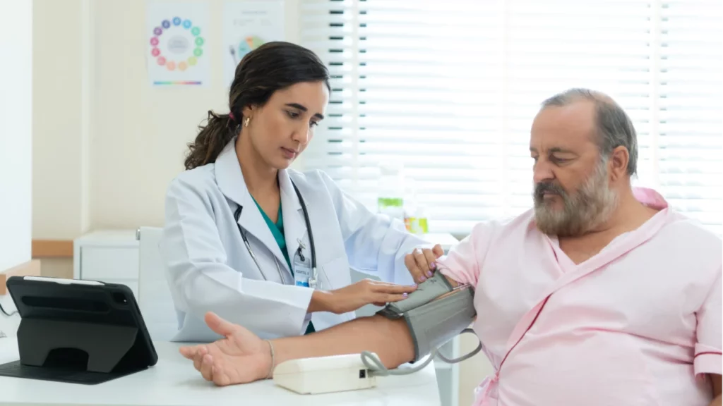 doctor checking patient blood pressure for remote monitoring