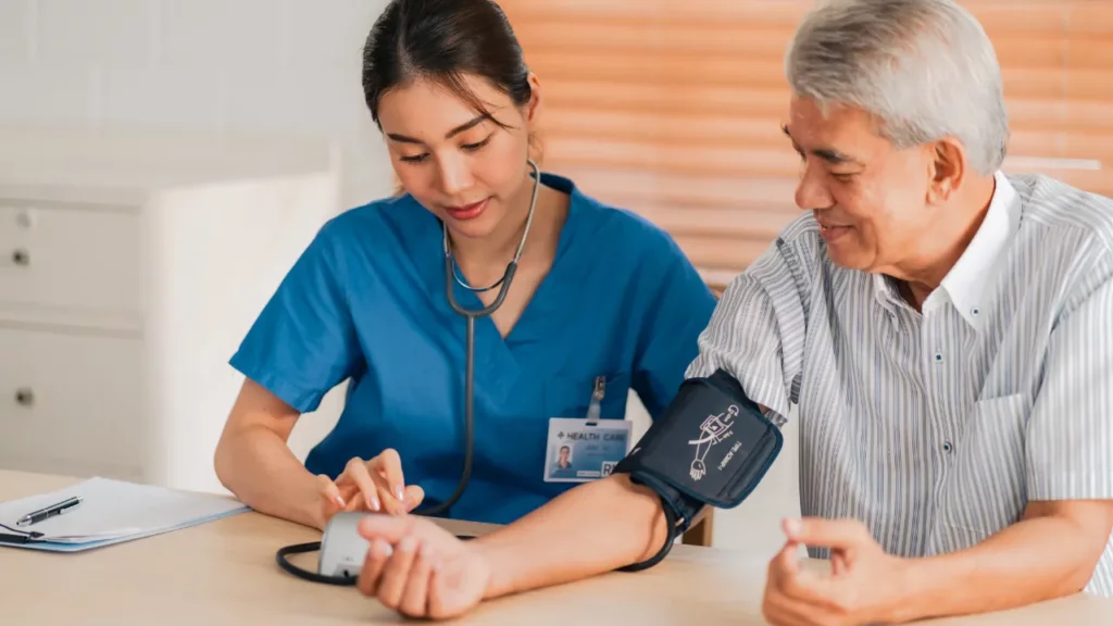 caregiver measuring patients blood pressure