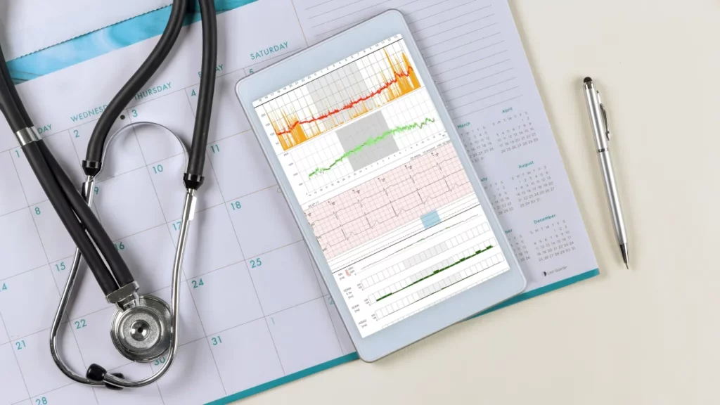 doctor desk with cardiogram wave heart report analysis in digital tablet