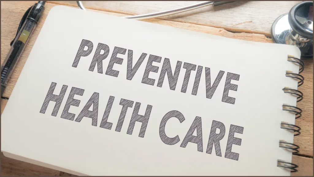 preventive health care text in a notebook with pen and stethoscope