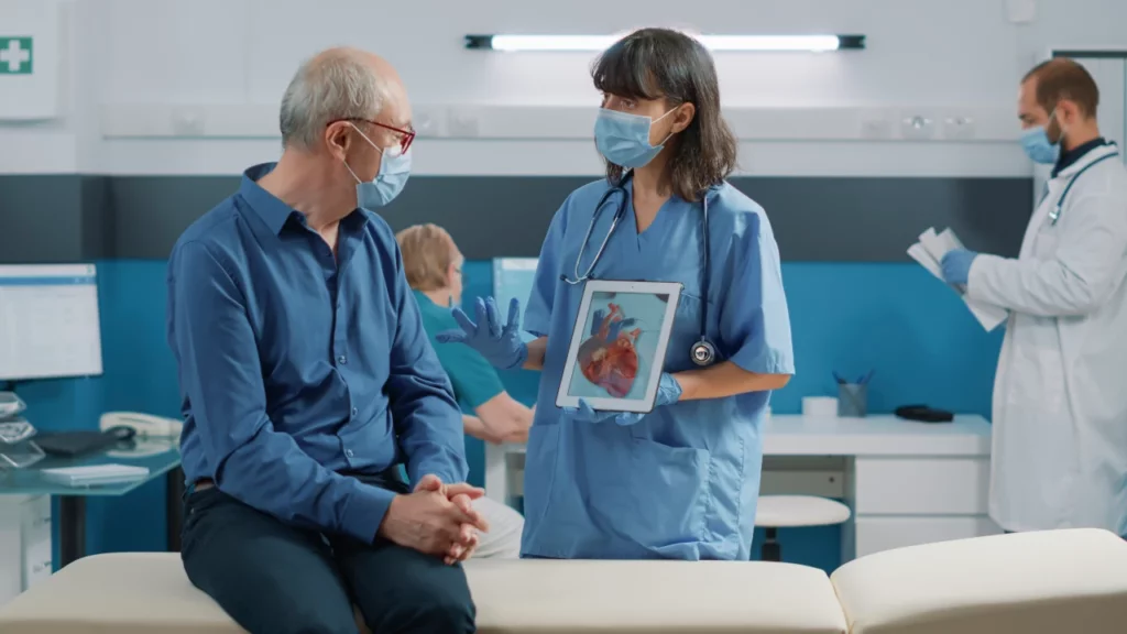 nurse explaining heart condition diagnosis