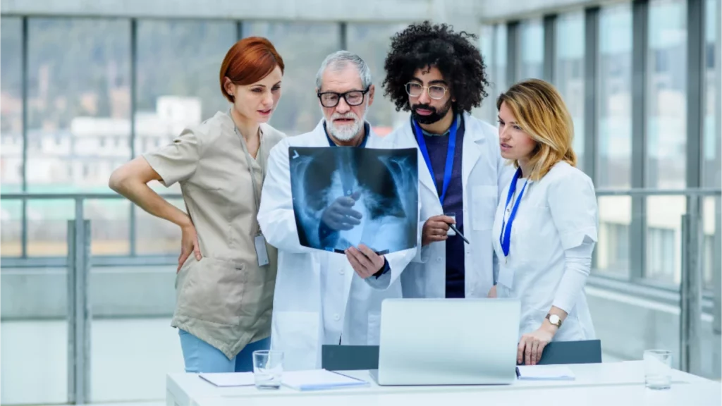 physicians reviewing x-ray image and planning chronic care strategies