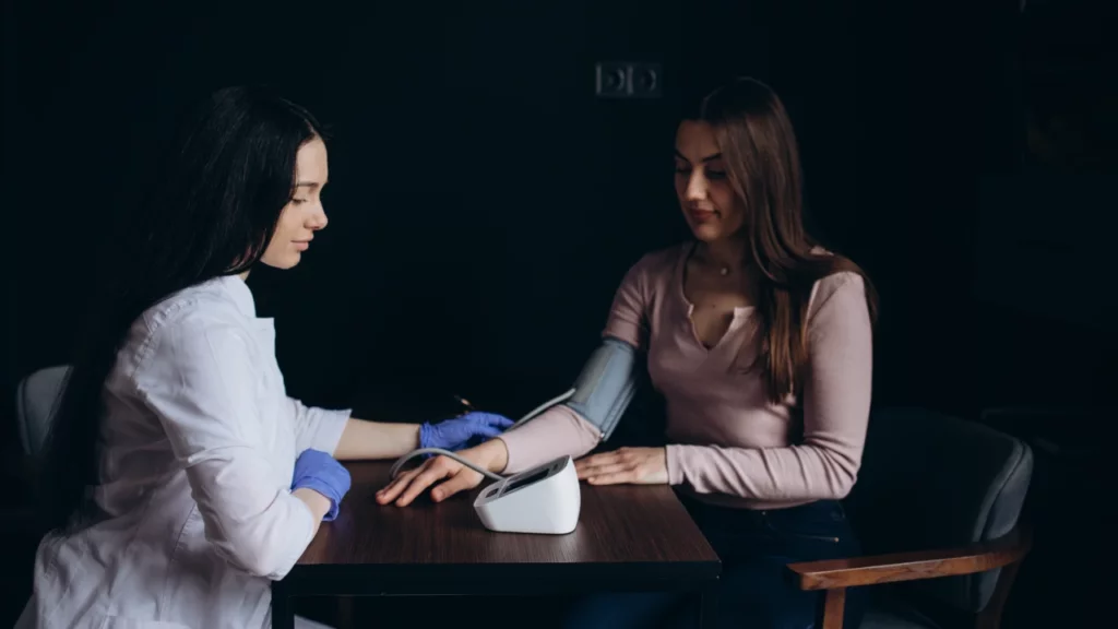 healthcare provider measuring patient blood pressure