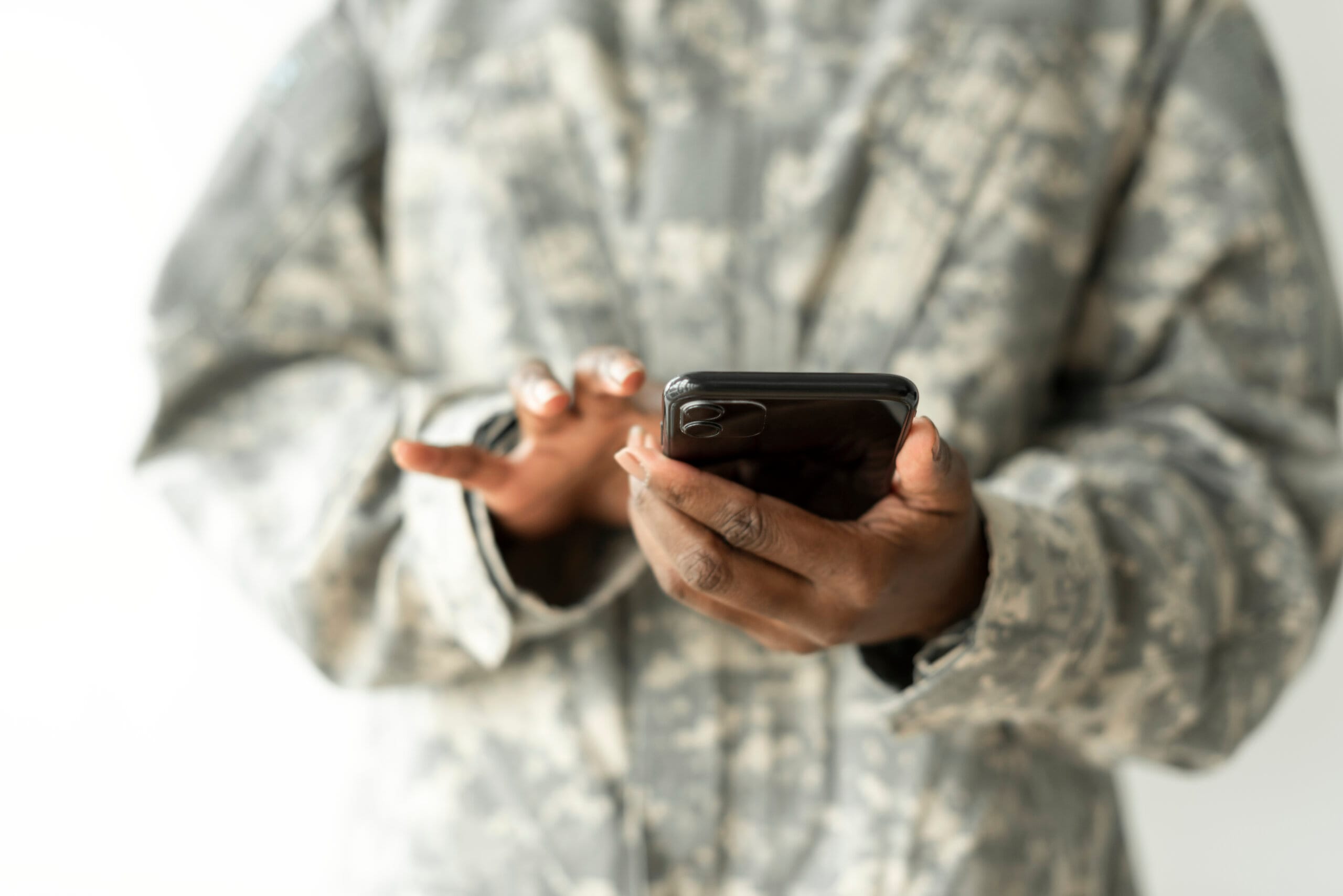 A counsellor with a clipboard talking with a service member in uniform